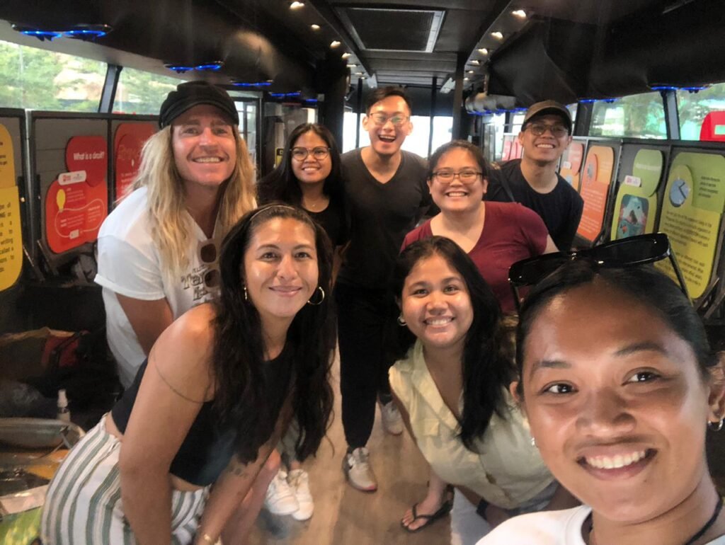 Group smiling together inside the Mind Museum Bus