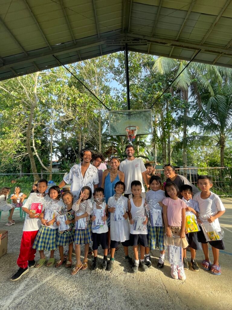 Students and volunteers holding school packs at Katipunan