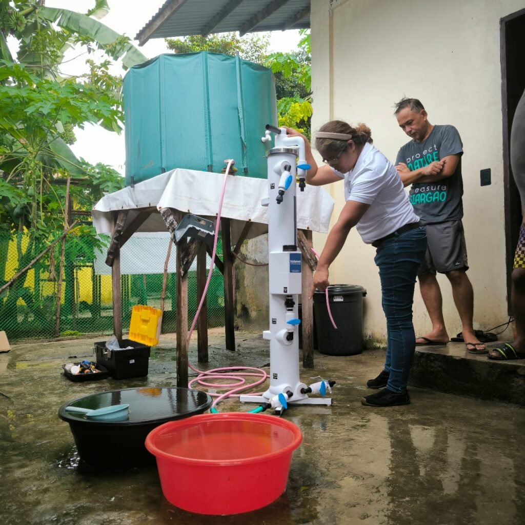 Demonstrating the SkyHydrant valves beside a water tank in Burgos